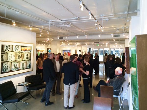 Fans and friends gather to explore Jacobs' work, featured prominently in this photo is "Sake Barrels"